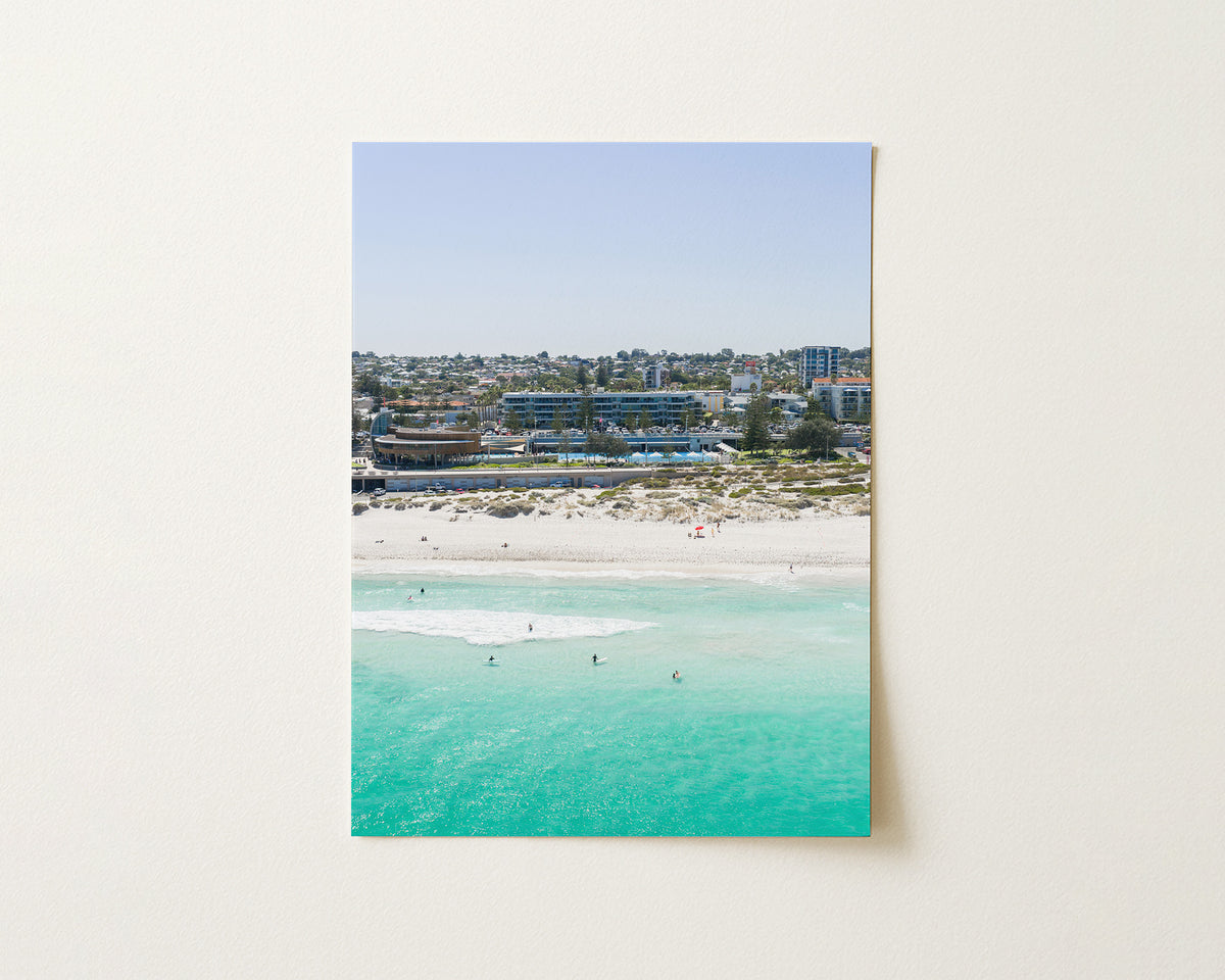 Fine art paper print of aerial photography of Scarborough Beach, buildings along the beachfront above turquoise shallows and white sand in portrait orientation