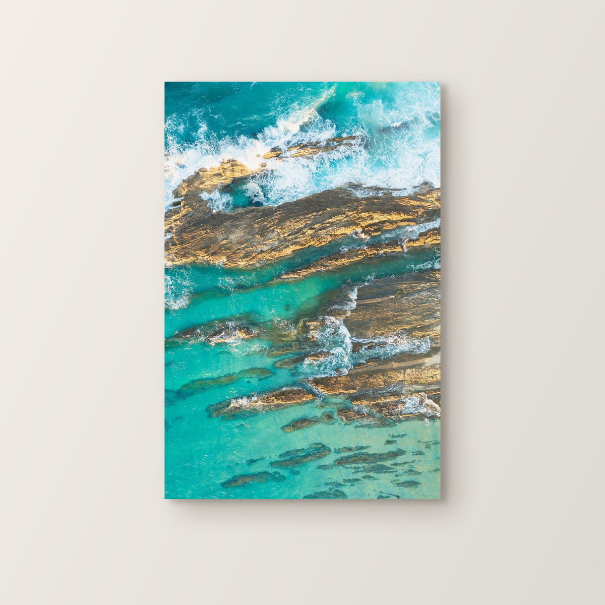 Stretched canvas print of aerial photography of Snapper Rocks, rock ridges and white foam in turquoise water in portrait orientation on a wall