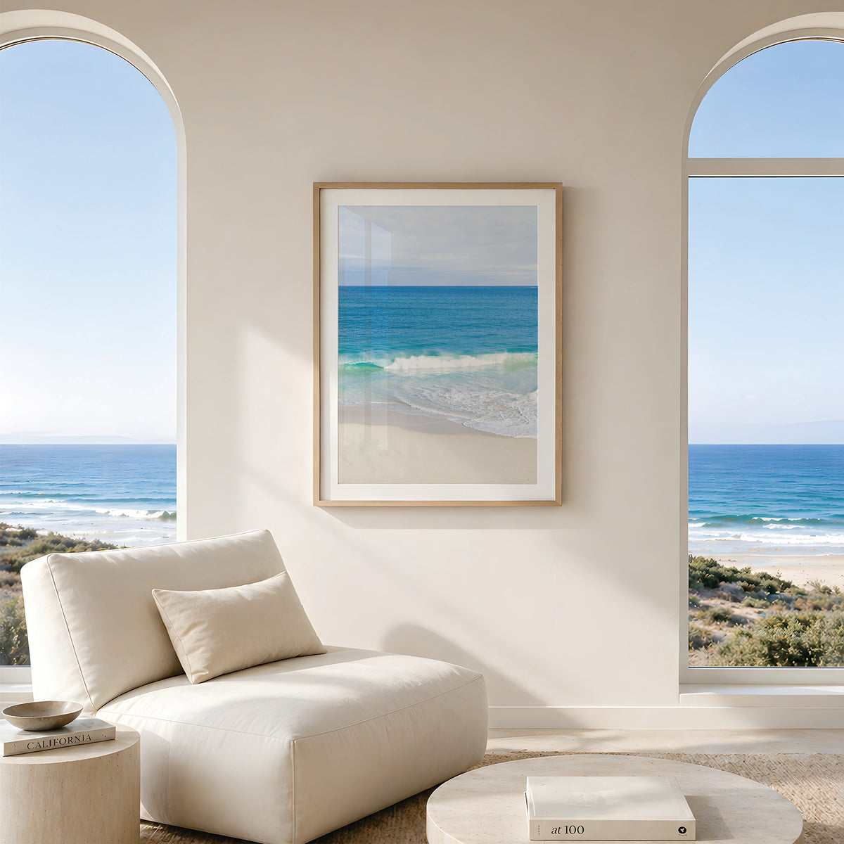 Framed canvas print of aerial photography of Alkimos Beach, a small wave rolling onto pale sand beneath a blue sea and cloudy sky in portrait orientation hanging in a living room