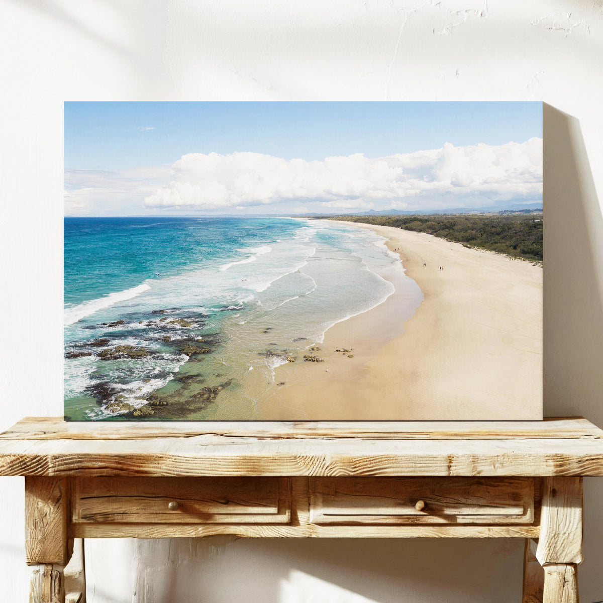 Aerial photograph of the wide beach and reef at Hastings Point NSW with the hinterland ranges behind, printed on stretched canvas