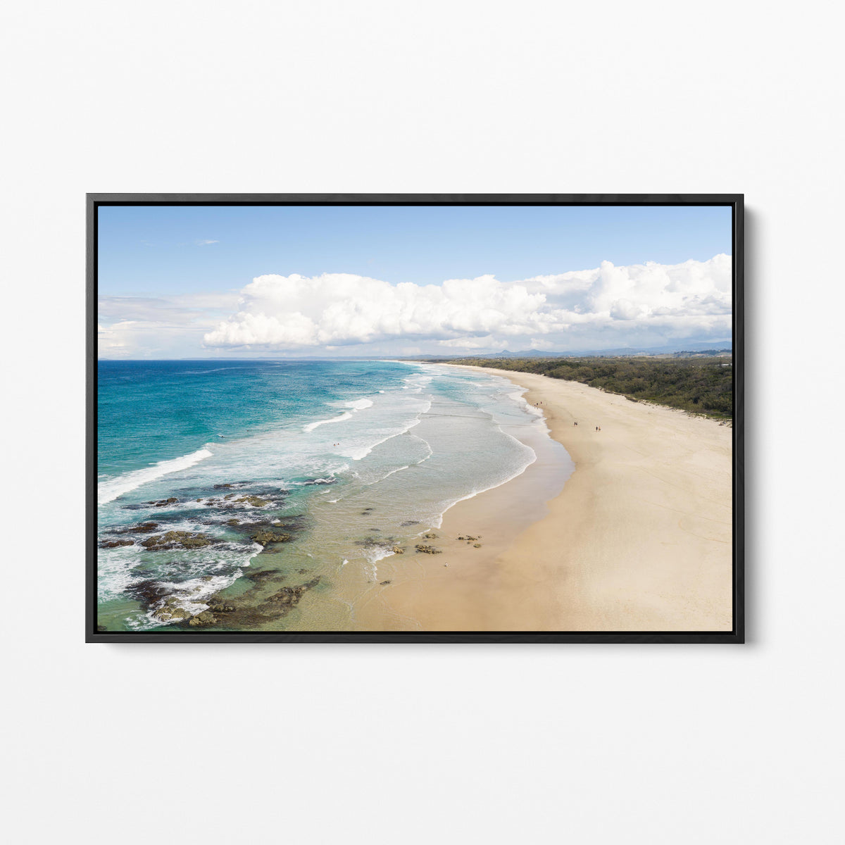 Aerial photograph of the wide beach and reef at Hastings Point NSW with the hinterland ranges behind, in a black frame