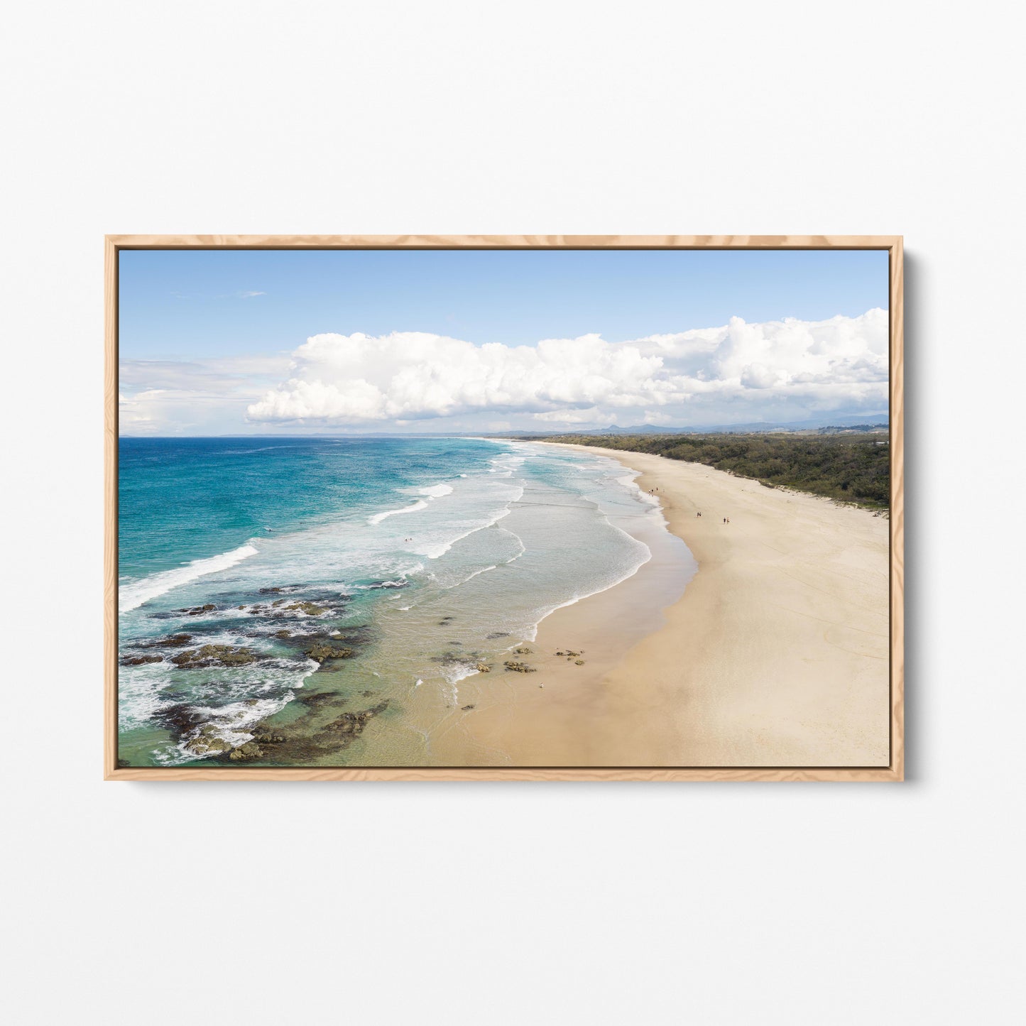 Aerial photograph of the wide beach and reef at Hastings Point NSW with the hinterland ranges behind, in an oak frame