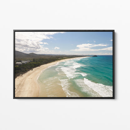 Aerial photograph of surf peeling along the length of Hastings Point beach NSW in a black frame