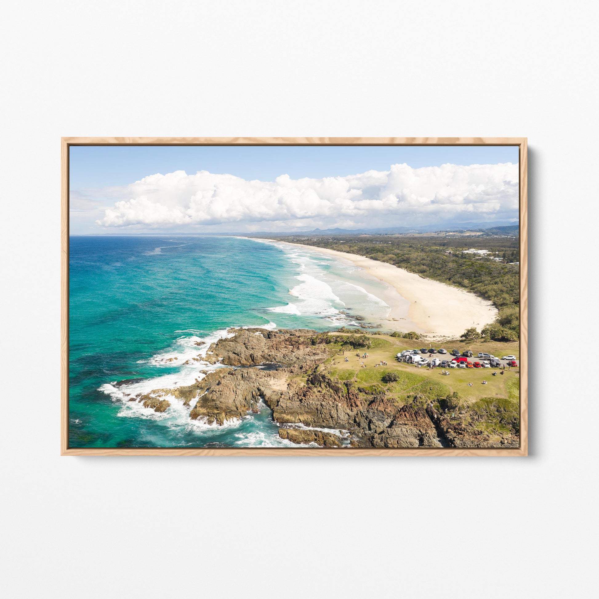 Aerial photograph of the green headland above the rocks at Hastings Point NSW in an oak frame