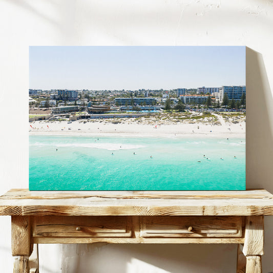 Stretched canvas print of aerial photography of Scarborough Beach, buildings along the beachfront above turquoise shallows and white sand on a console table