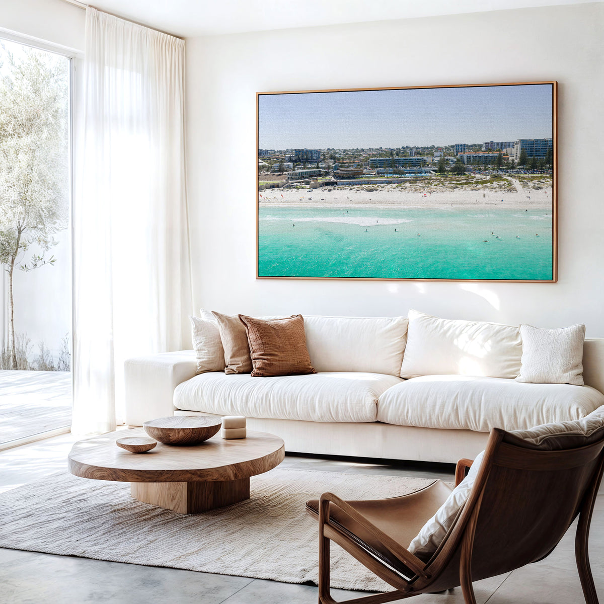 Canvas print of aerial photography of Scarborough Beach, buildings along the beachfront above turquoise shallows and white sand hanging above a sofa in a living room