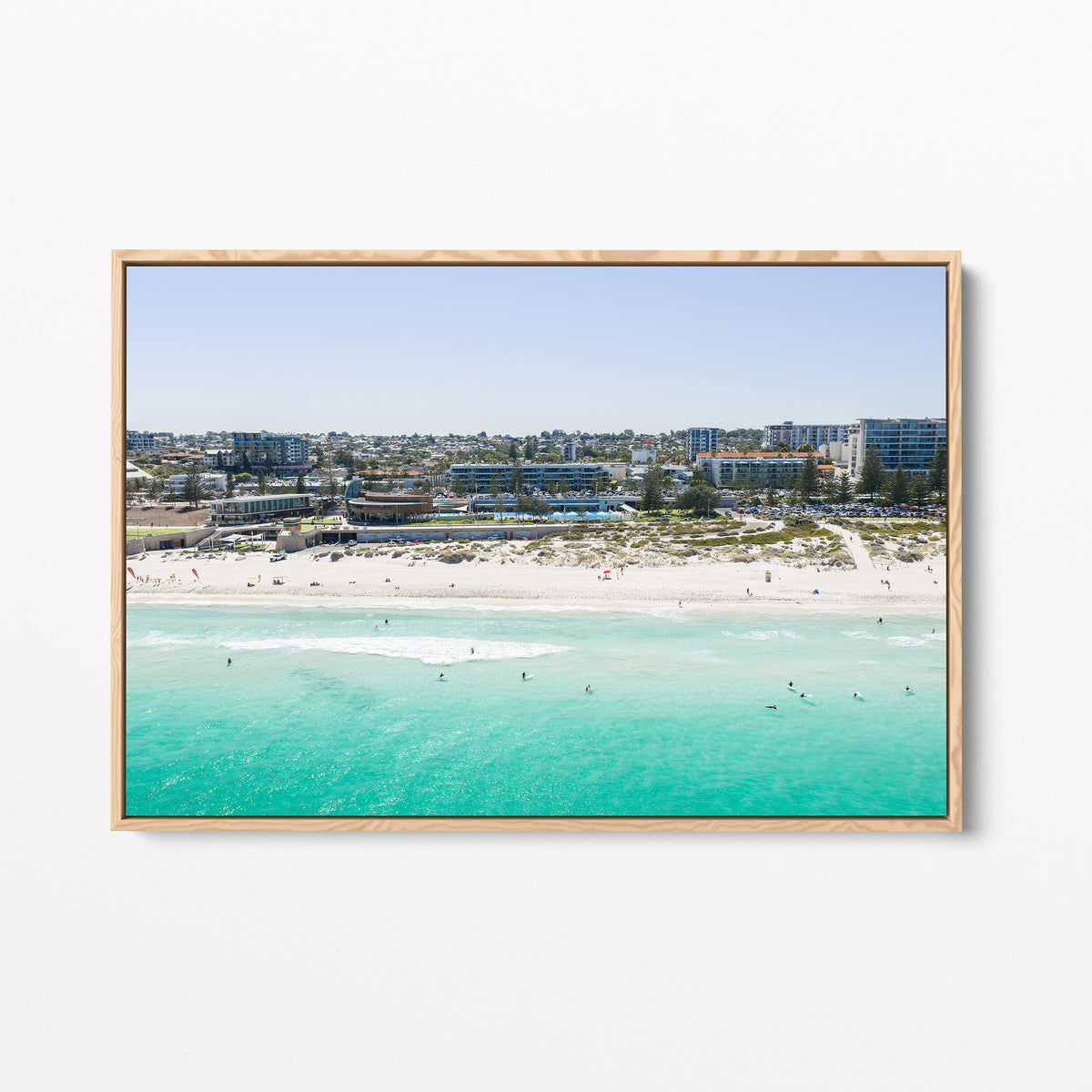 Oak framed canvas print of aerial photography of Scarborough Beach, buildings along the beachfront above turquoise shallows and white sand