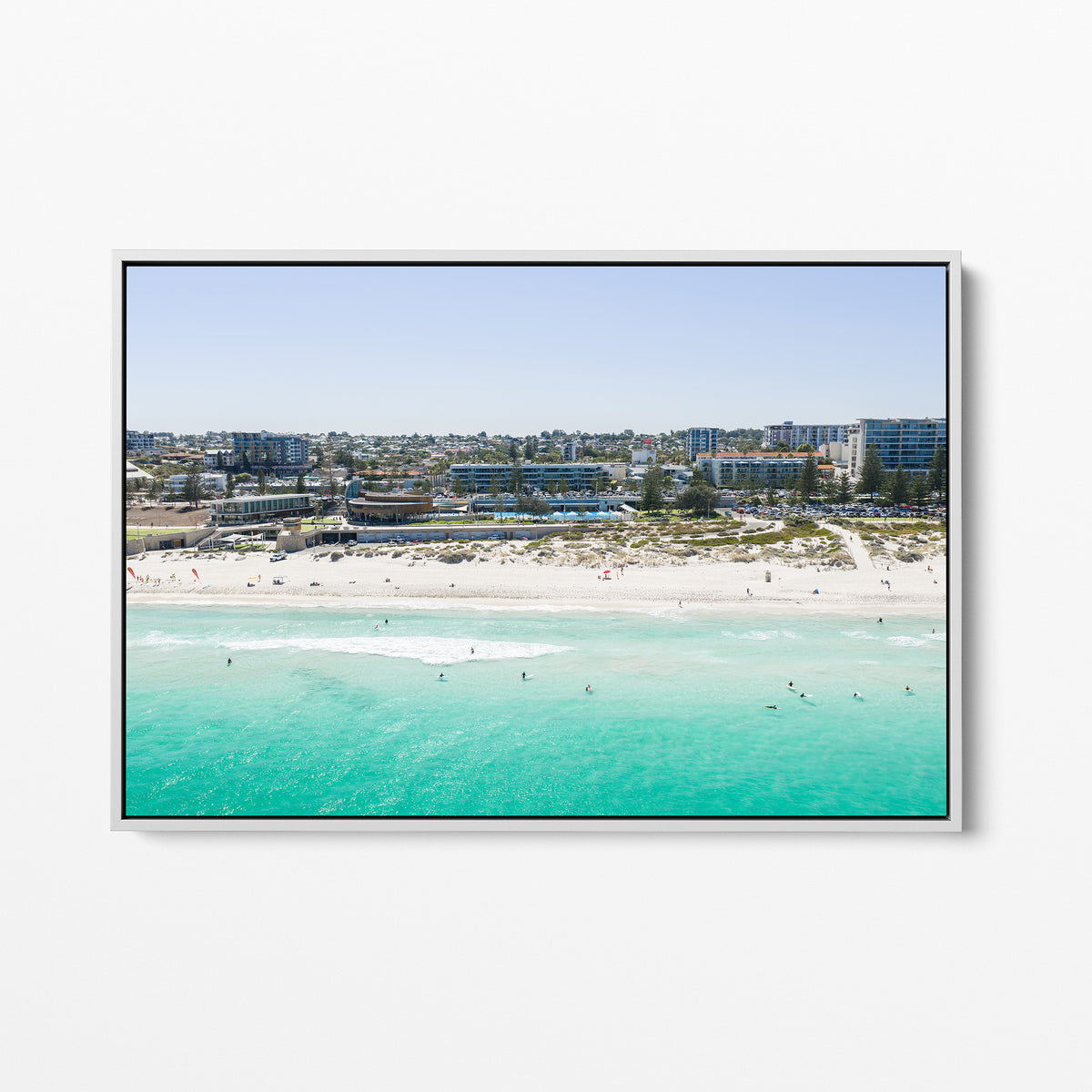 White framed canvas print of aerial photography of Scarborough Beach, buildings along the beachfront above turquoise shallows and white sand