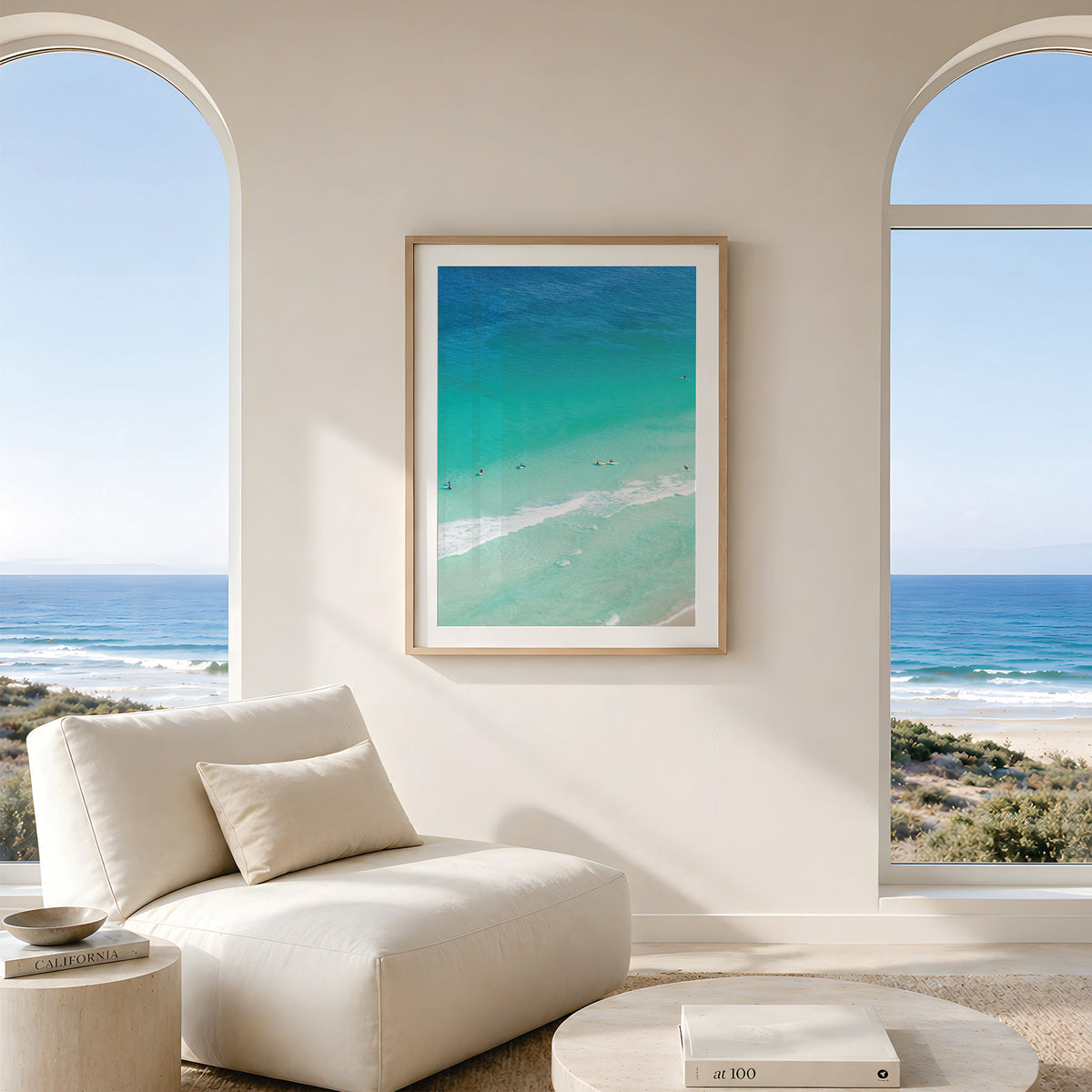 Framed canvas print of aerial photography of Scarborough Beach, surfers and swimmers in deep turquoise water along a diagonal shoreline in portrait orientation hanging in a living room