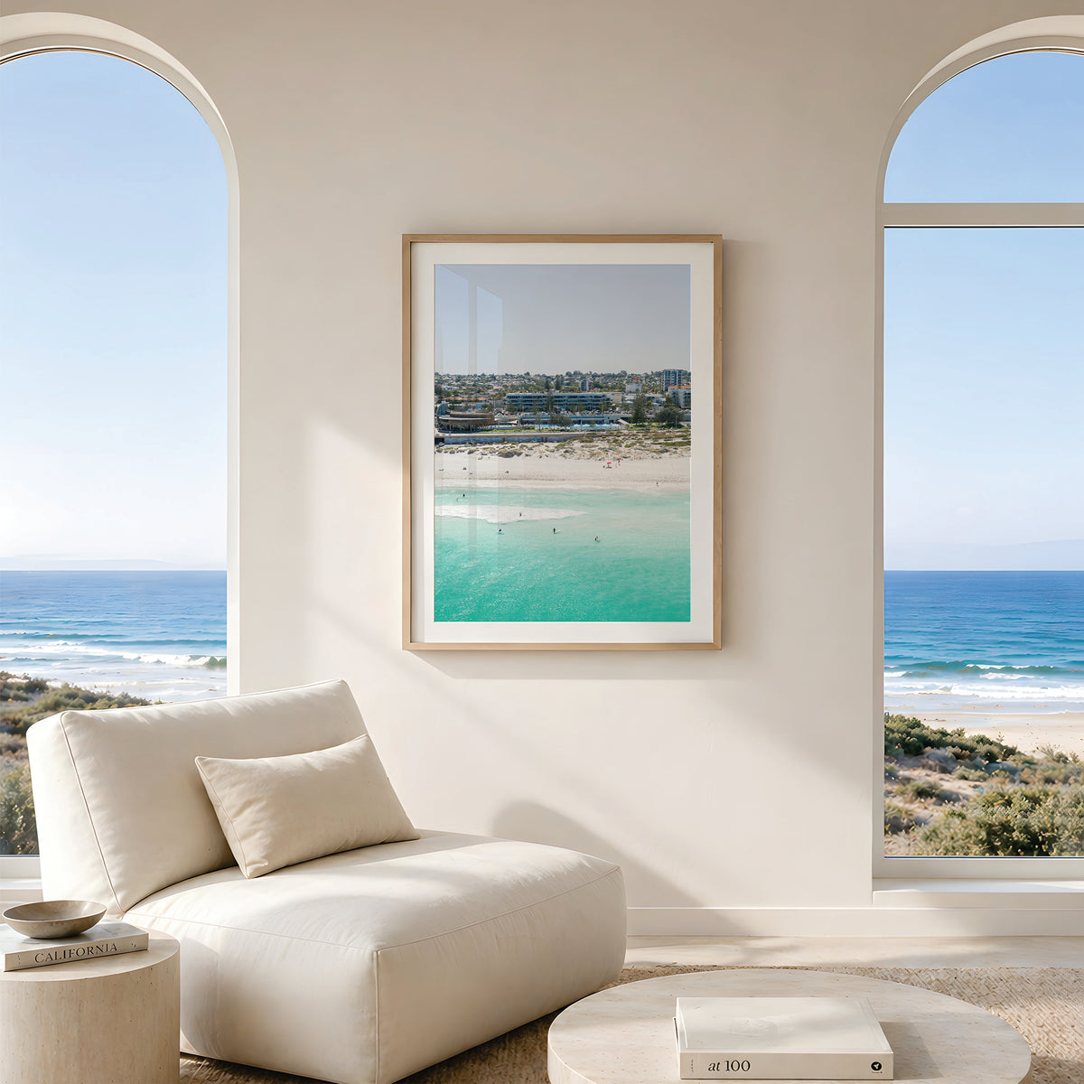 Framed canvas print of aerial photography of Scarborough Beach, buildings along the beachfront above turquoise shallows and white sand in portrait orientation hanging in a living room