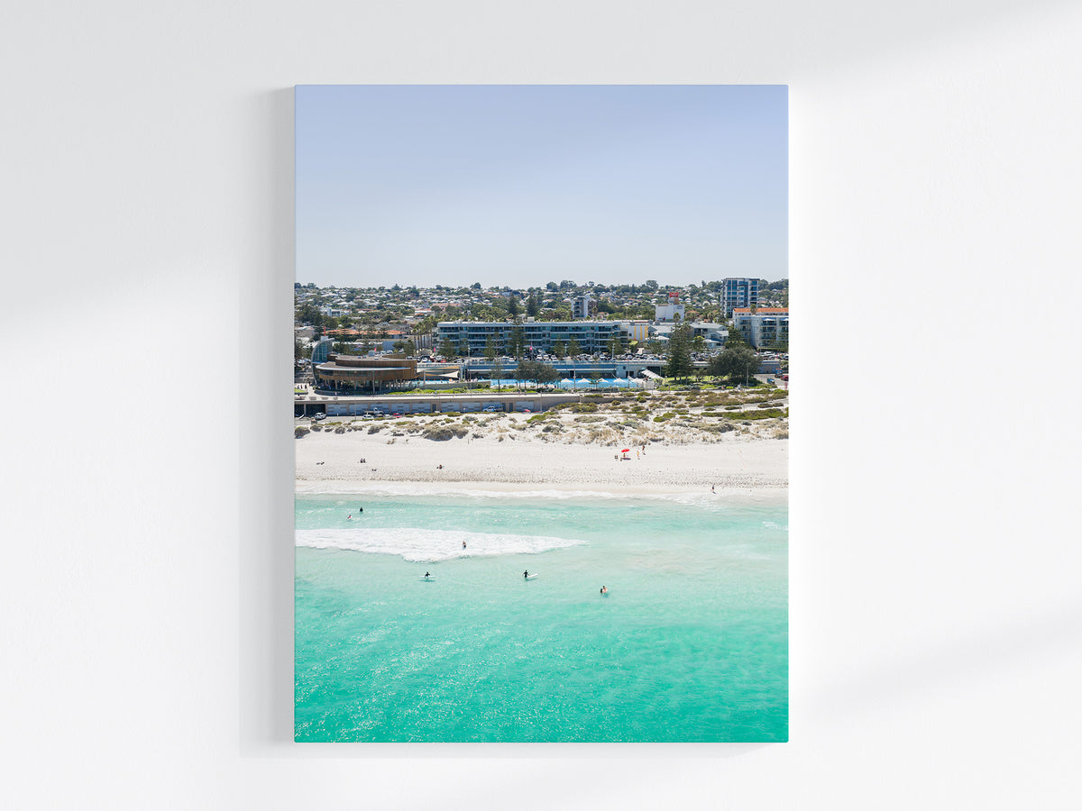 Stretched canvas print of aerial photography of Scarborough Beach, buildings along the beachfront above turquoise shallows and white sand in portrait orientation on a wall