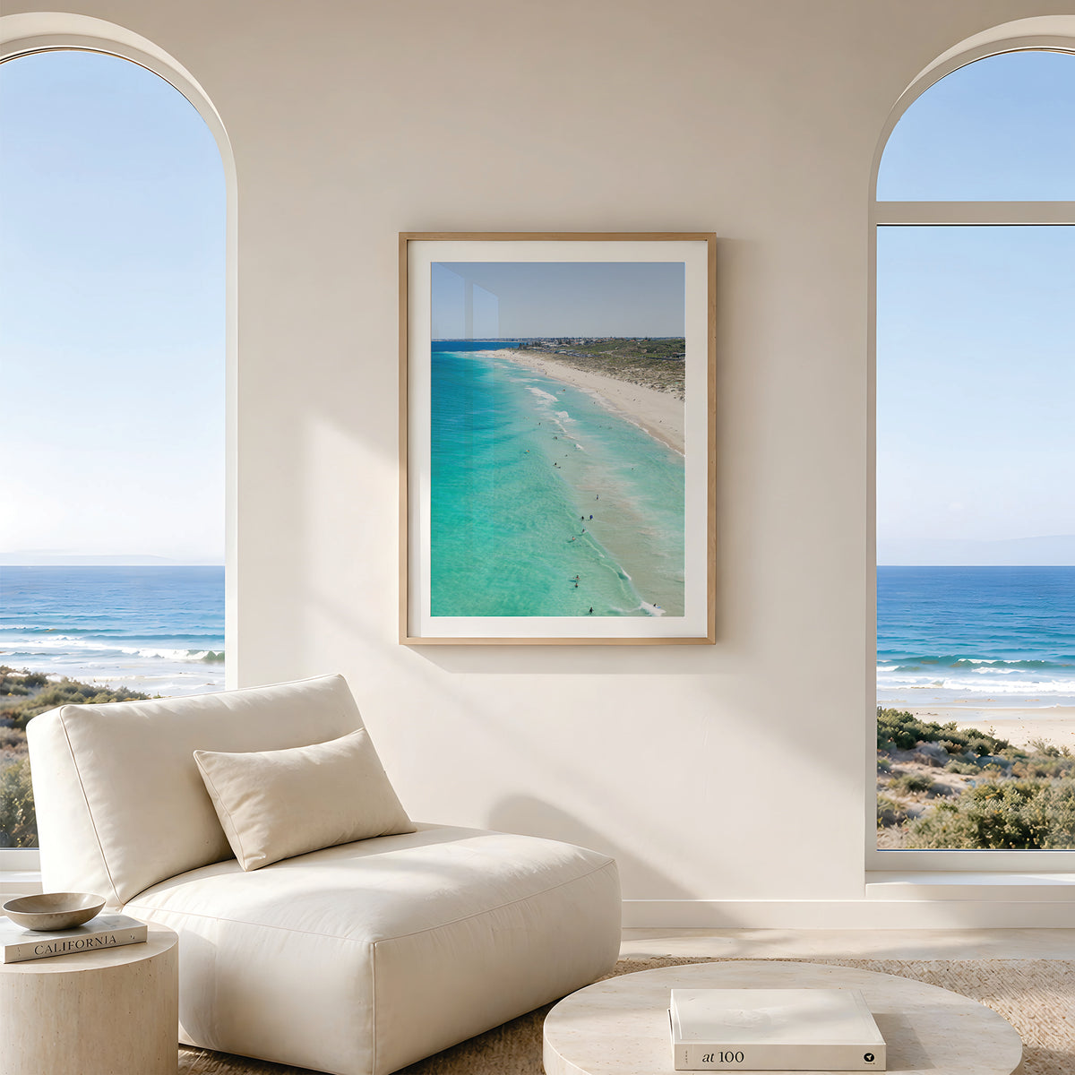 Framed canvas print of aerial photography of Trigg Beach, a long curving beach with turquoise water, white sand and coastal bush in portrait orientation hanging in a living room