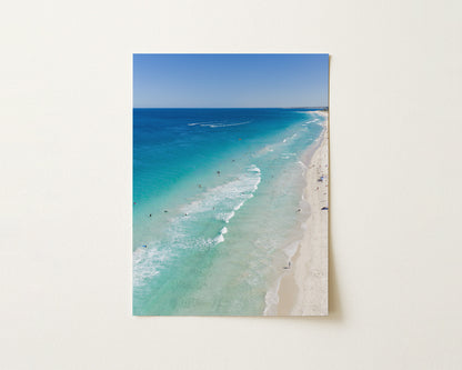 Fine art paper print of aerial photography of Scarborough Beach, deep blue water, turquoise shallows and pale sand along a diagonal shore in portrait orientation