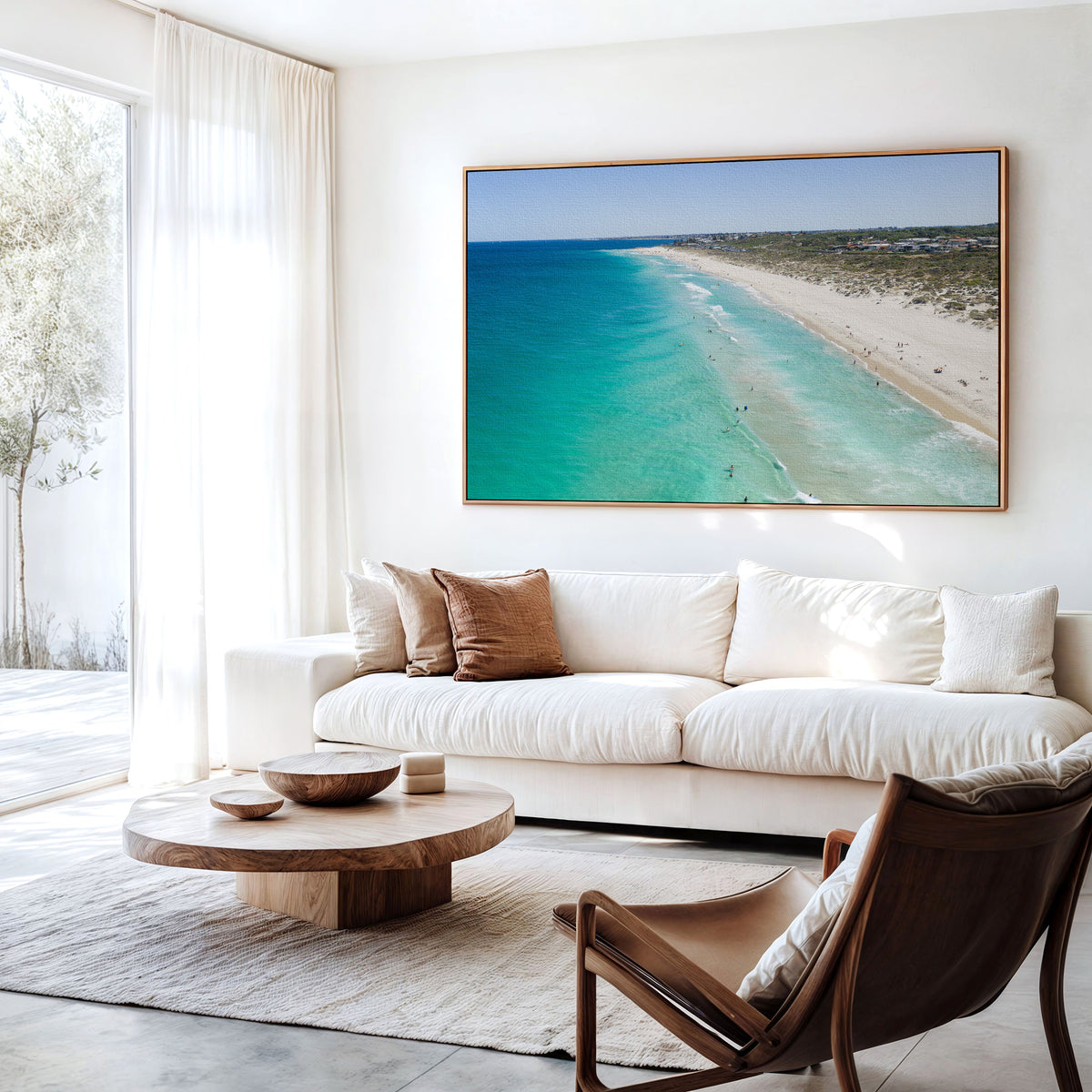 Canvas print of aerial photography of Trigg Beach, a long curving beach with turquoise water, white sand and coastal bush hanging above a sofa in a living room