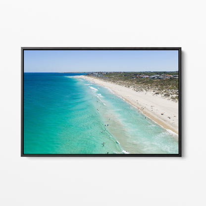 Black framed canvas print of aerial photography of Trigg Beach, a long curving beach with turquoise water, white sand and coastal bush