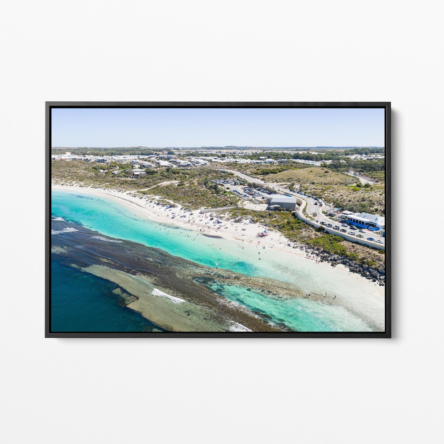 Yanchep Lagoon beach and the suburb behind it, in a black frame