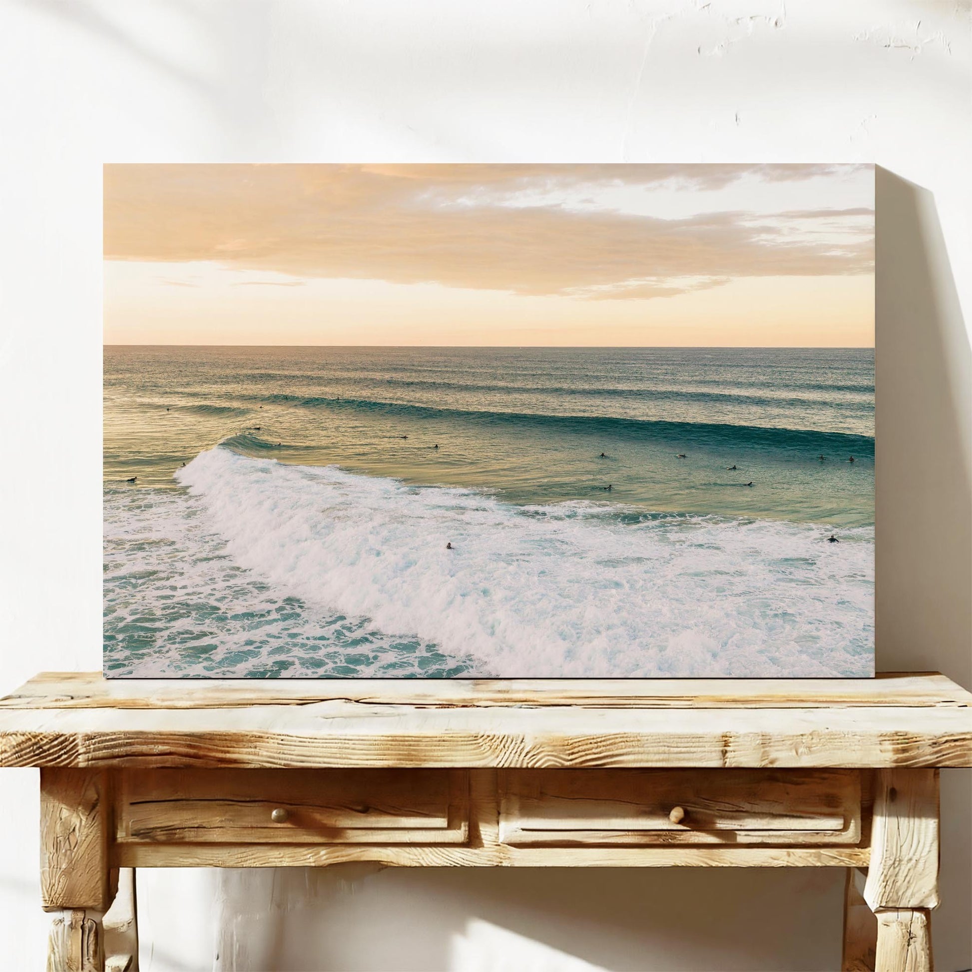 Stretched canvas print of a long line of swell at Duranbah Beach at sunset, leaning on a timber bench