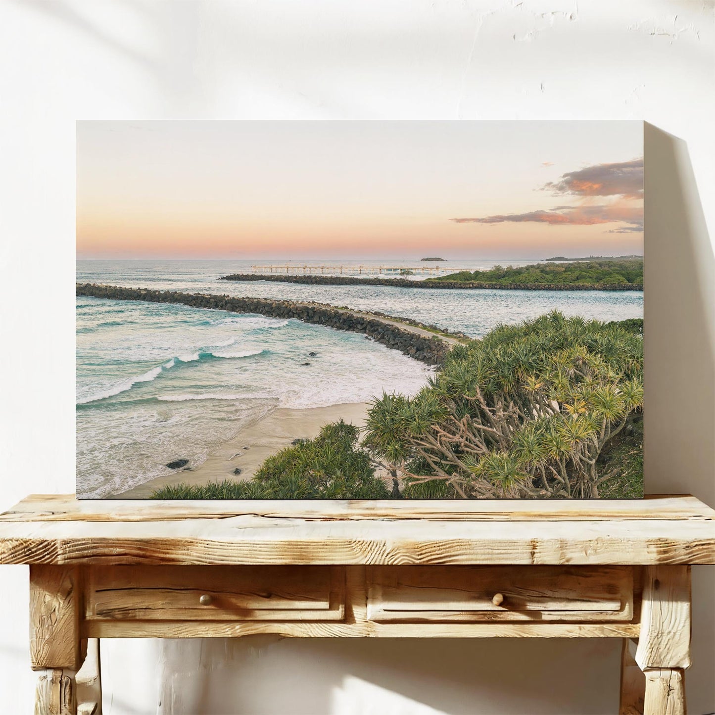 Stretched canvas print of the breakwall at Duranbah Beach at sunset, leaning on a timber bench