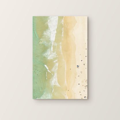 Stretched canvas print of aerial photography of Dreamtime Beach, golden sand and wave lines along the shore in portrait orientation on a wall