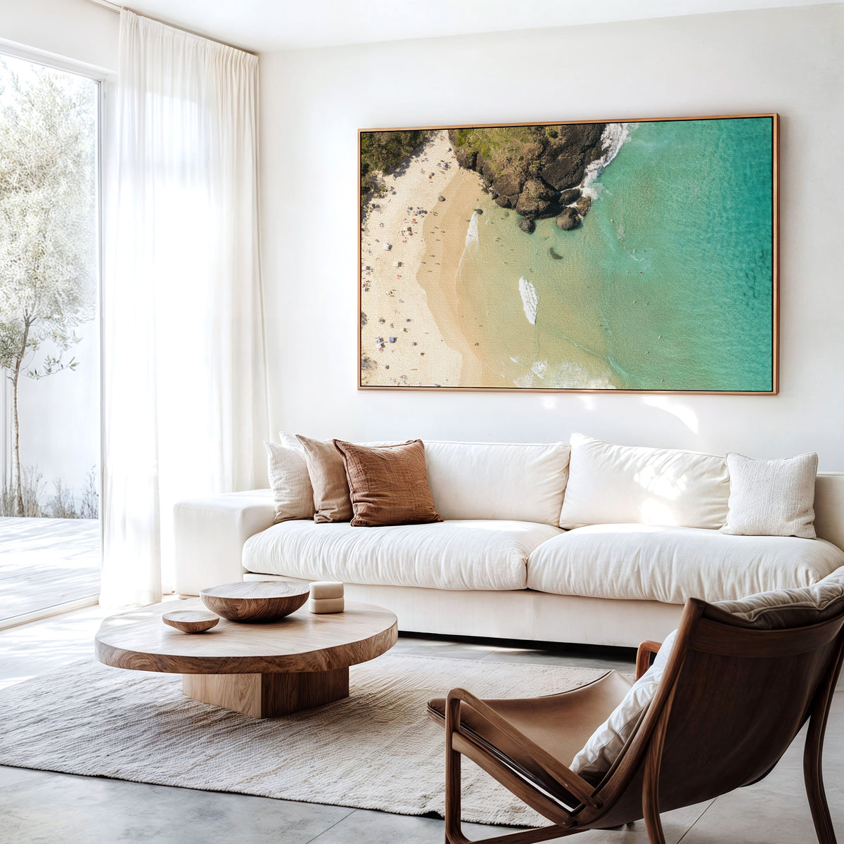 Canvas print of aerial photography of Dreamtime Beach, headland rocks with sand, turquoise water and a small white boat hanging above a sofa in a living room