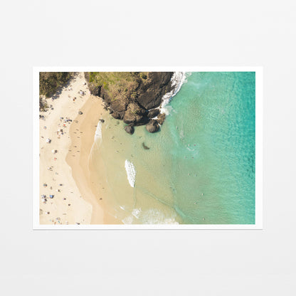 Fine art paper print of aerial photography of Dreamtime Beach, headland rocks with sand, turquoise water and a small white boat with a white border