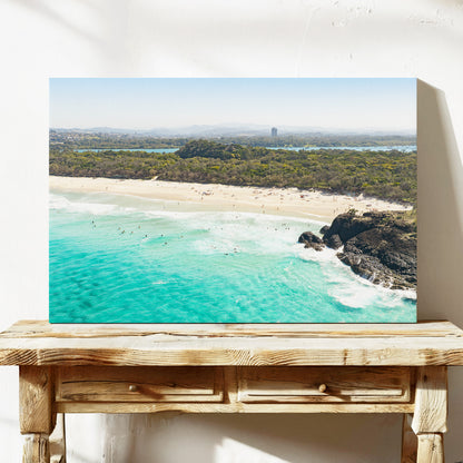 Stretched canvas print of aerial photography of Dreamtime Beach, green coastal bush, a rock outcrop and turquoise water on a console table