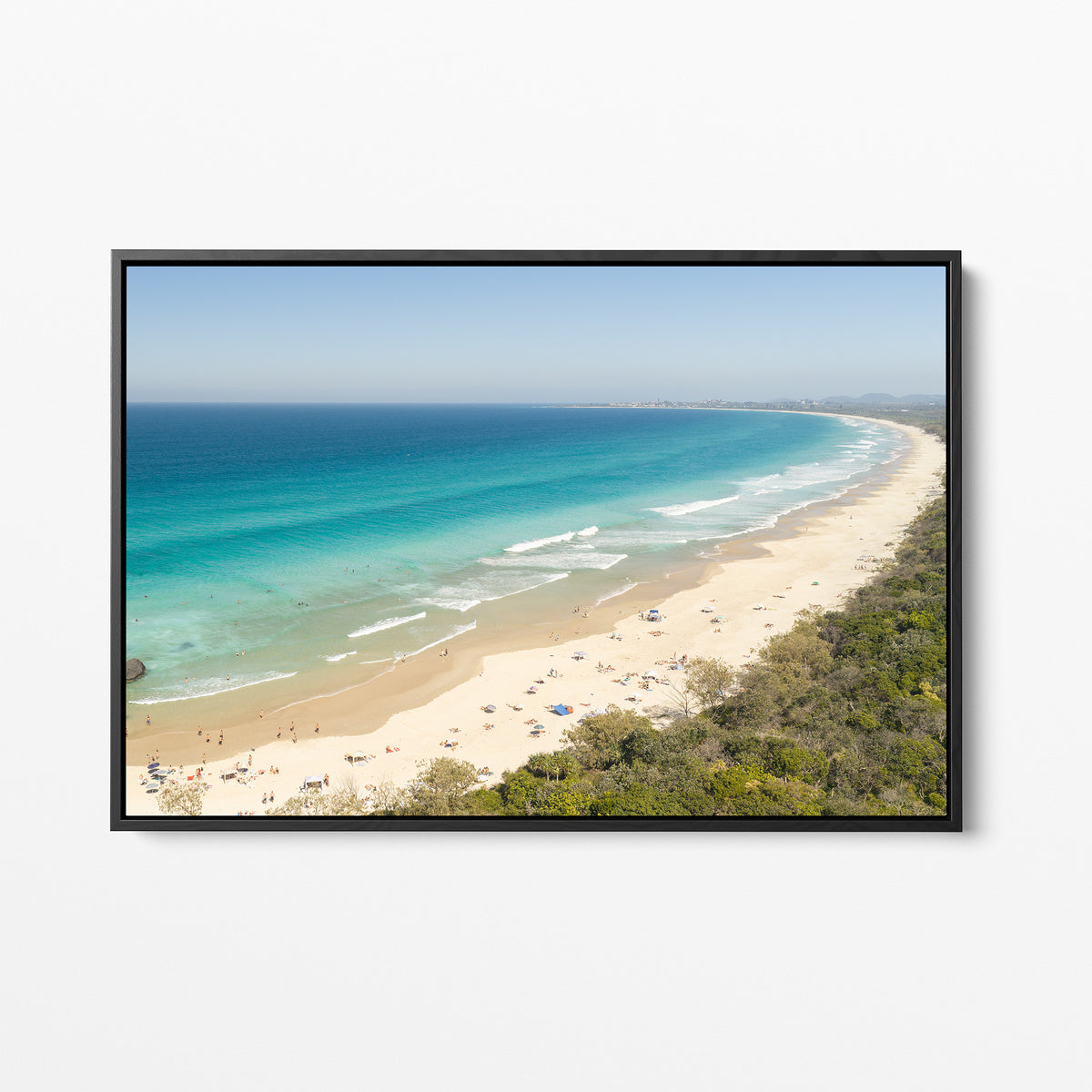 Black framed canvas print of aerial photography of Dreamtime Beach, a long curving beach with turquoise water and coastal bush