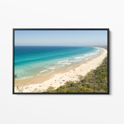 Black framed canvas print of aerial photography of Dreamtime Beach, a long curving beach with turquoise water and coastal bush