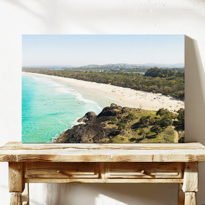 Stretched canvas print of aerial photography of Dreamtime Beach, a bush covered headland above a long beach and turquoise water on a console table