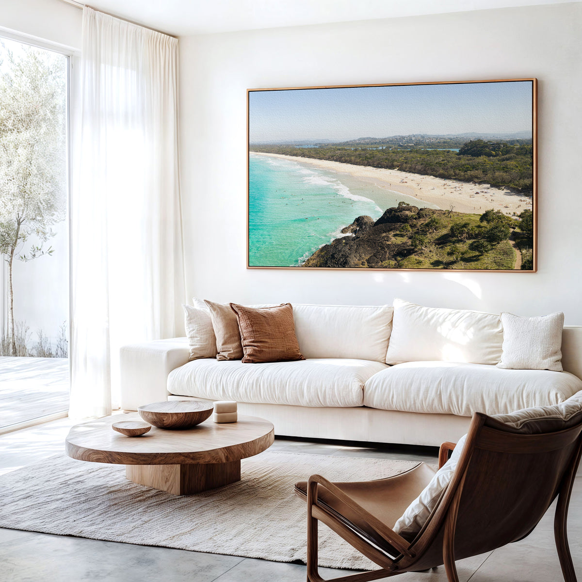 Canvas print of aerial photography of Dreamtime Beach, a bush covered headland above a long beach and turquoise water hanging above a sofa in a living room