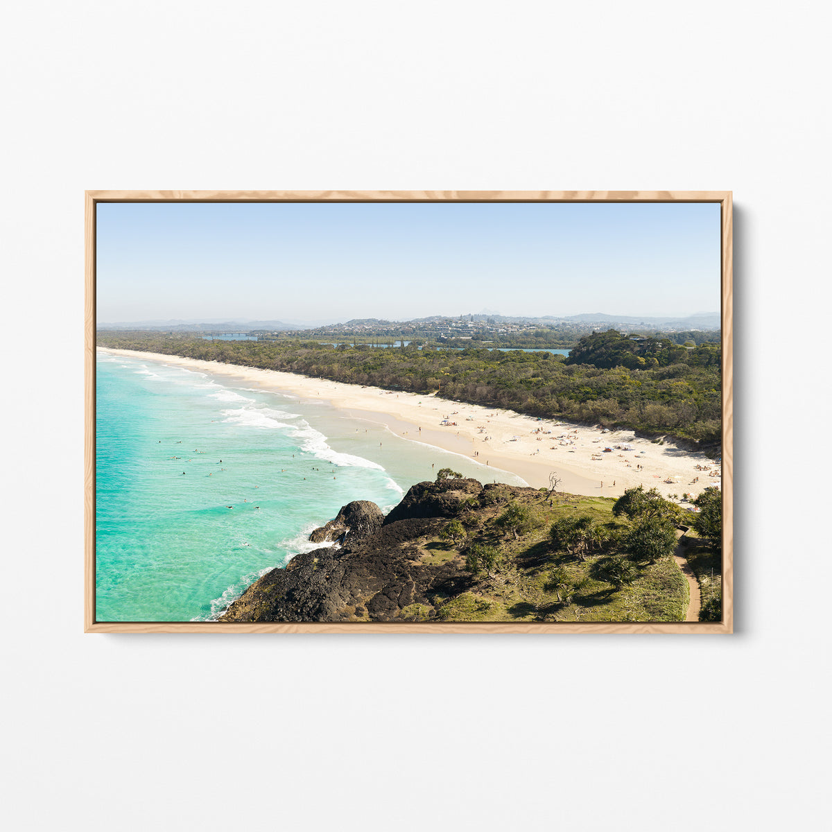 Oak framed canvas print of aerial photography of Dreamtime Beach, a bush covered headland above a long beach and turquoise water