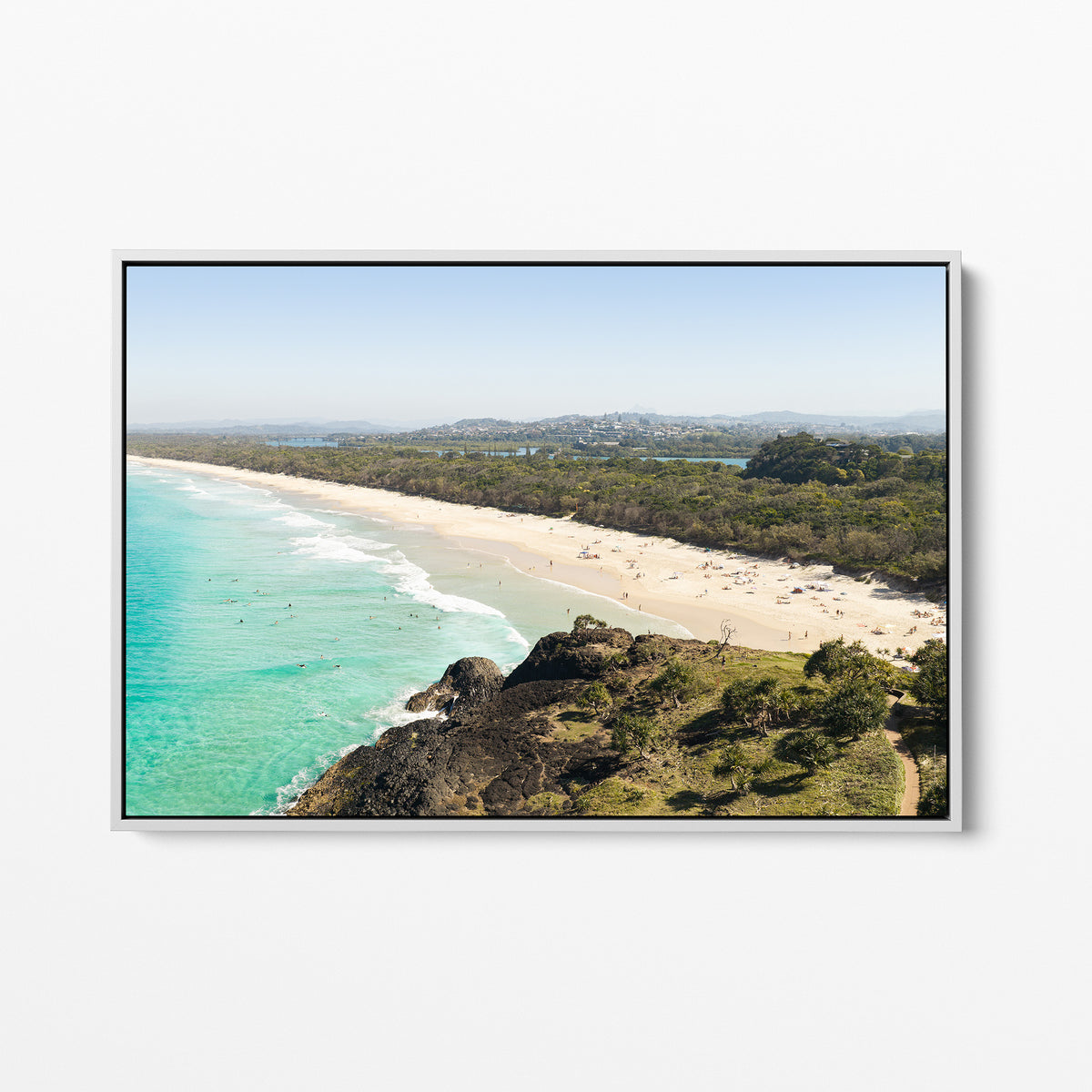 White framed canvas print of aerial photography of Dreamtime Beach, a bush covered headland above a long beach and turquoise water