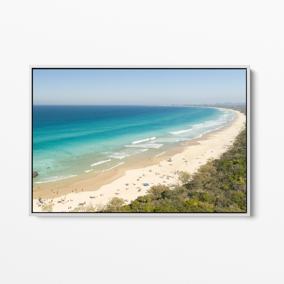 White framed canvas print of aerial photography of Dreamtime Beach, a long curving beach with turquoise water and coastal bush