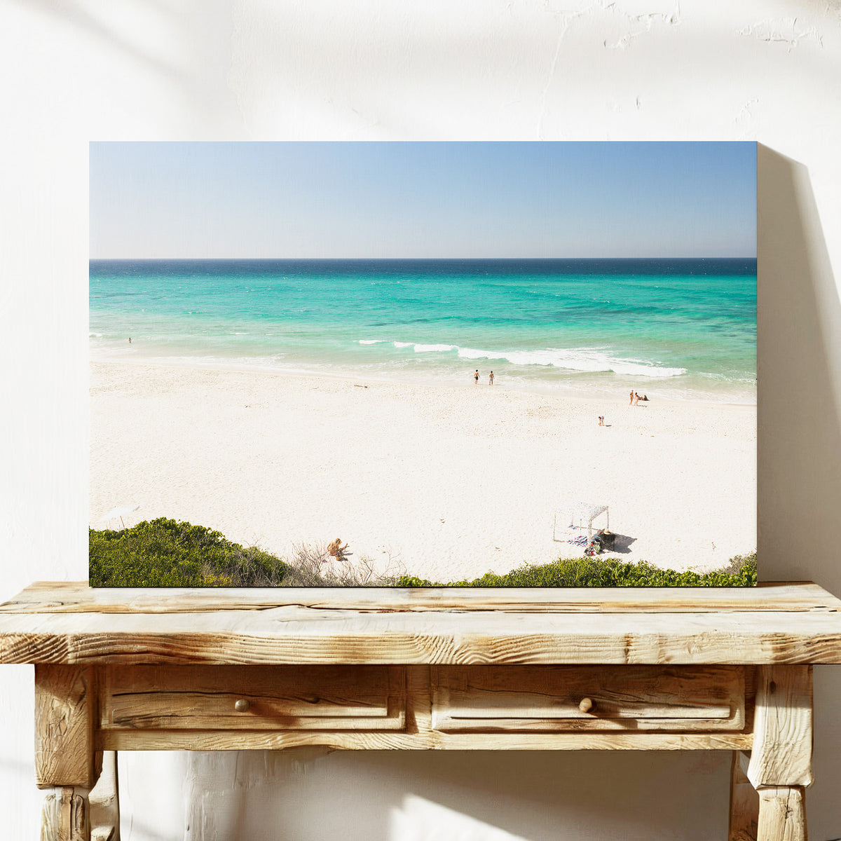 Stretched canvas print of aerial photography of Fingal Head, white sand and turquoise water with a small structure and bush at the bottom on a console table