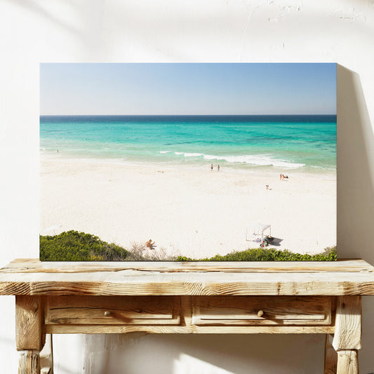 Stretched canvas print of aerial photography of Fingal Head, white sand and turquoise water with a small structure and bush at the bottom on a console table
