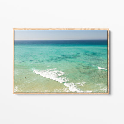 Oak framed canvas print of aerial photography of Fingal Head, turquoise water with white wave lines running across the shallows