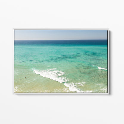 White framed canvas print of aerial photography of Fingal Head, turquoise water with white wave lines running across the shallows