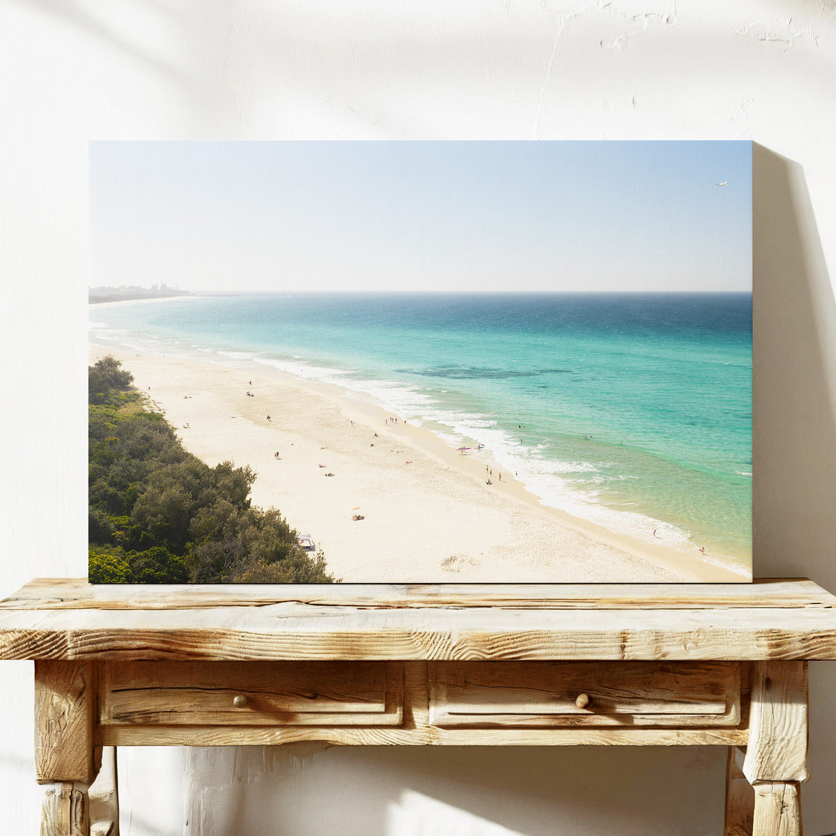 Stretched canvas print of aerial photography of Fingal Head, a pale sand beach with coastal bush in the bottom left and turquoise water on a console table
