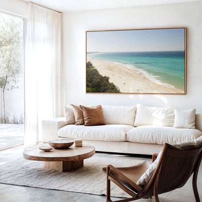 Canvas print of aerial photography of Fingal Head, a pale sand beach with coastal bush in the bottom left and turquoise water hanging above a sofa in a living room