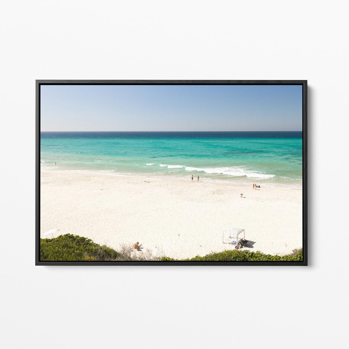 Black framed canvas print of aerial photography of Fingal Head, white sand and turquoise water with a small structure and bush at the bottom