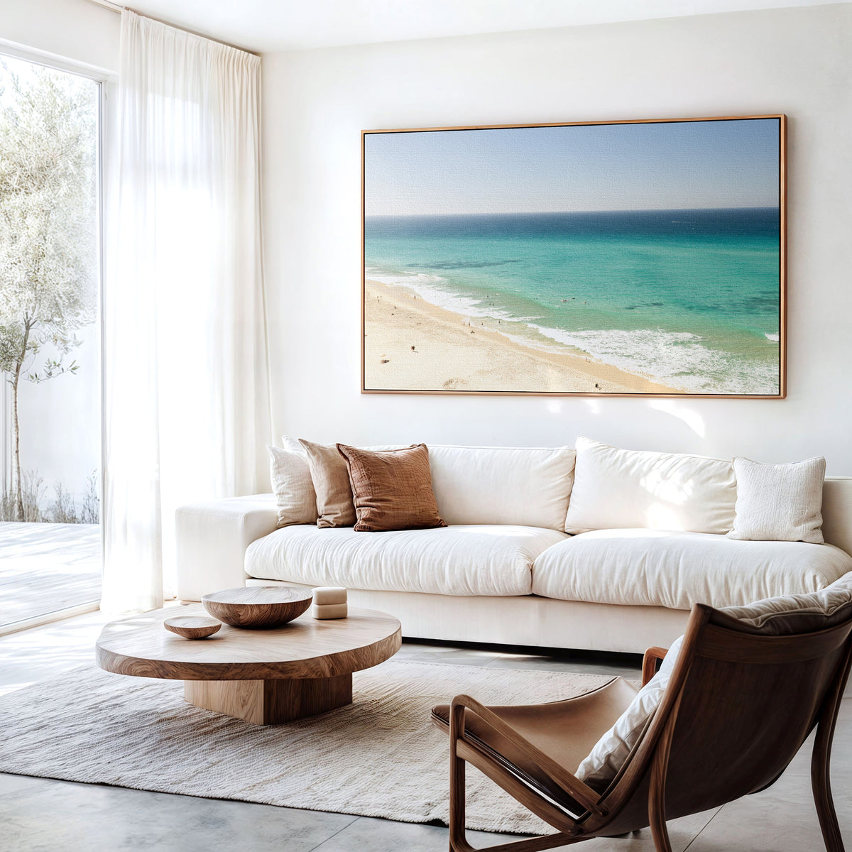 Canvas print of aerial photography of Fingal Head, a long strip of sand with turquoise surf rolling onto the shore hanging above a sofa in a living room