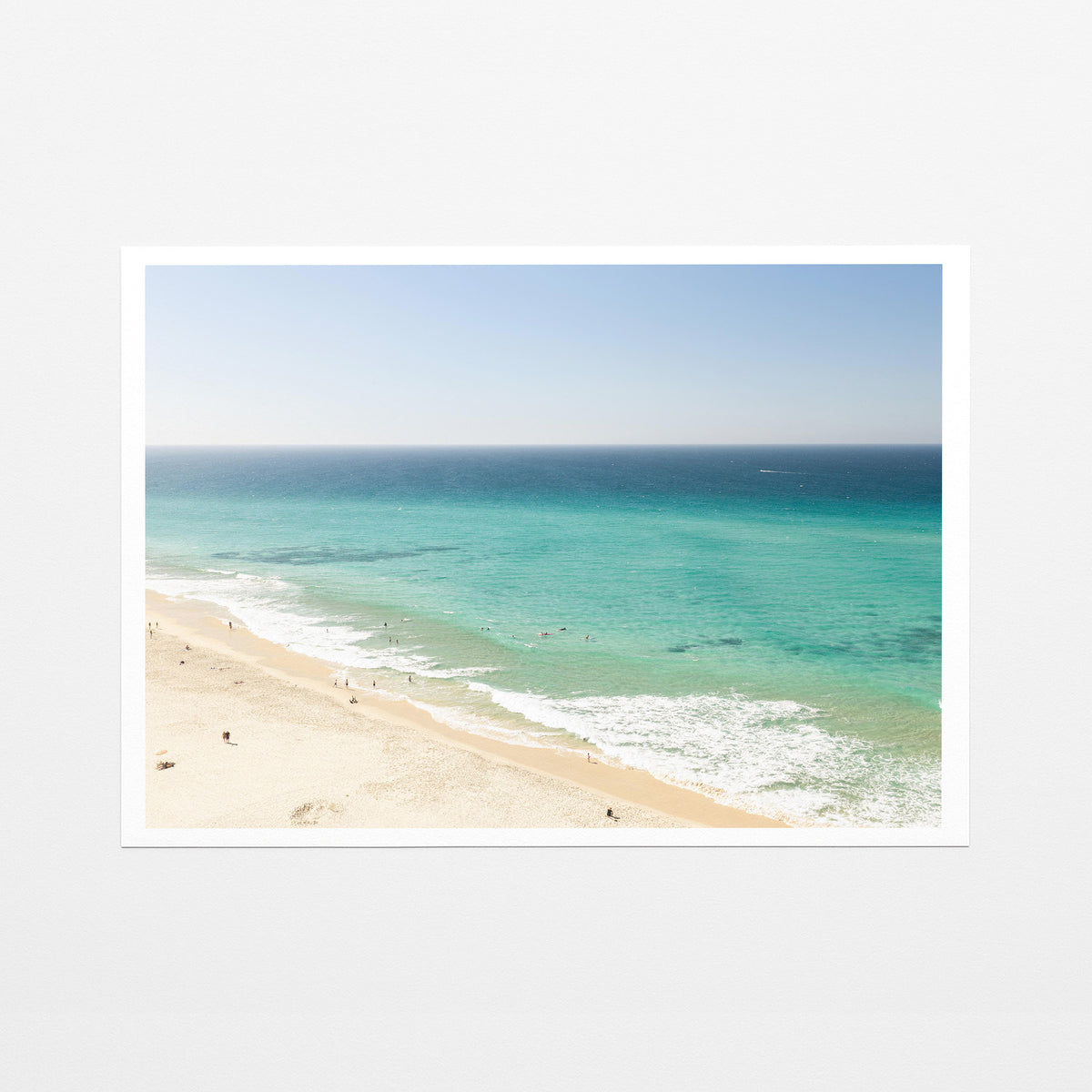 Fine art paper print of aerial photography of Fingal Head, a long strip of sand with turquoise surf rolling onto the shore with a white border