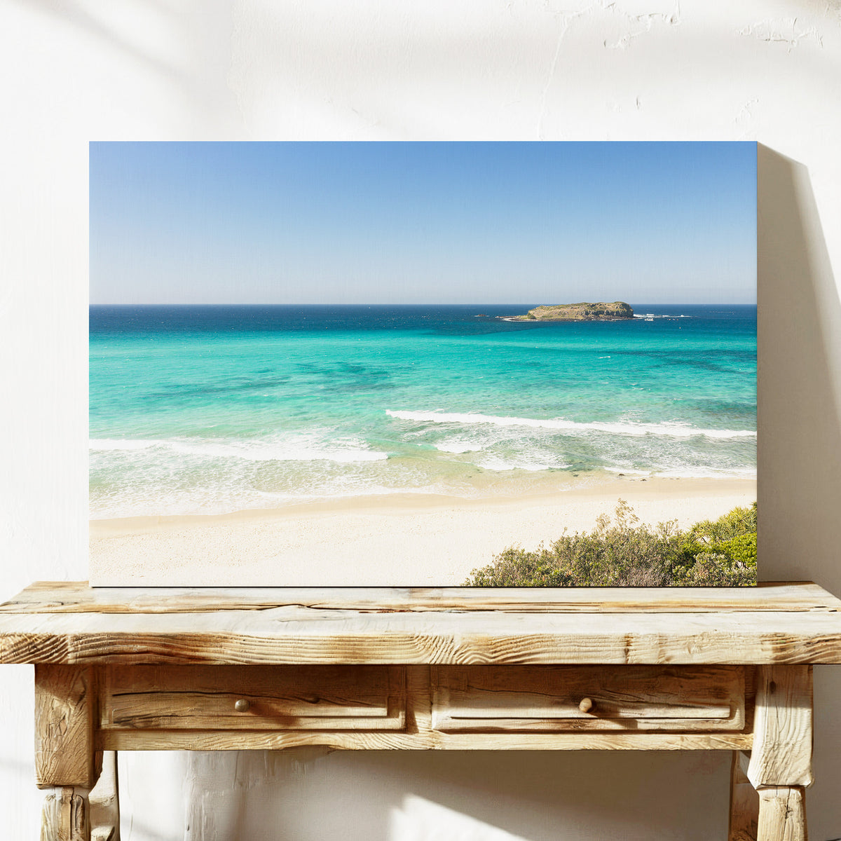 Stretched canvas print of aerial photography of Fingal Head, a beach with a small island offshore and turquoise water on a console table