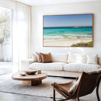 Canvas print of aerial photography of Fingal Head, a beach with a small island offshore and turquoise water hanging above a sofa in a living room