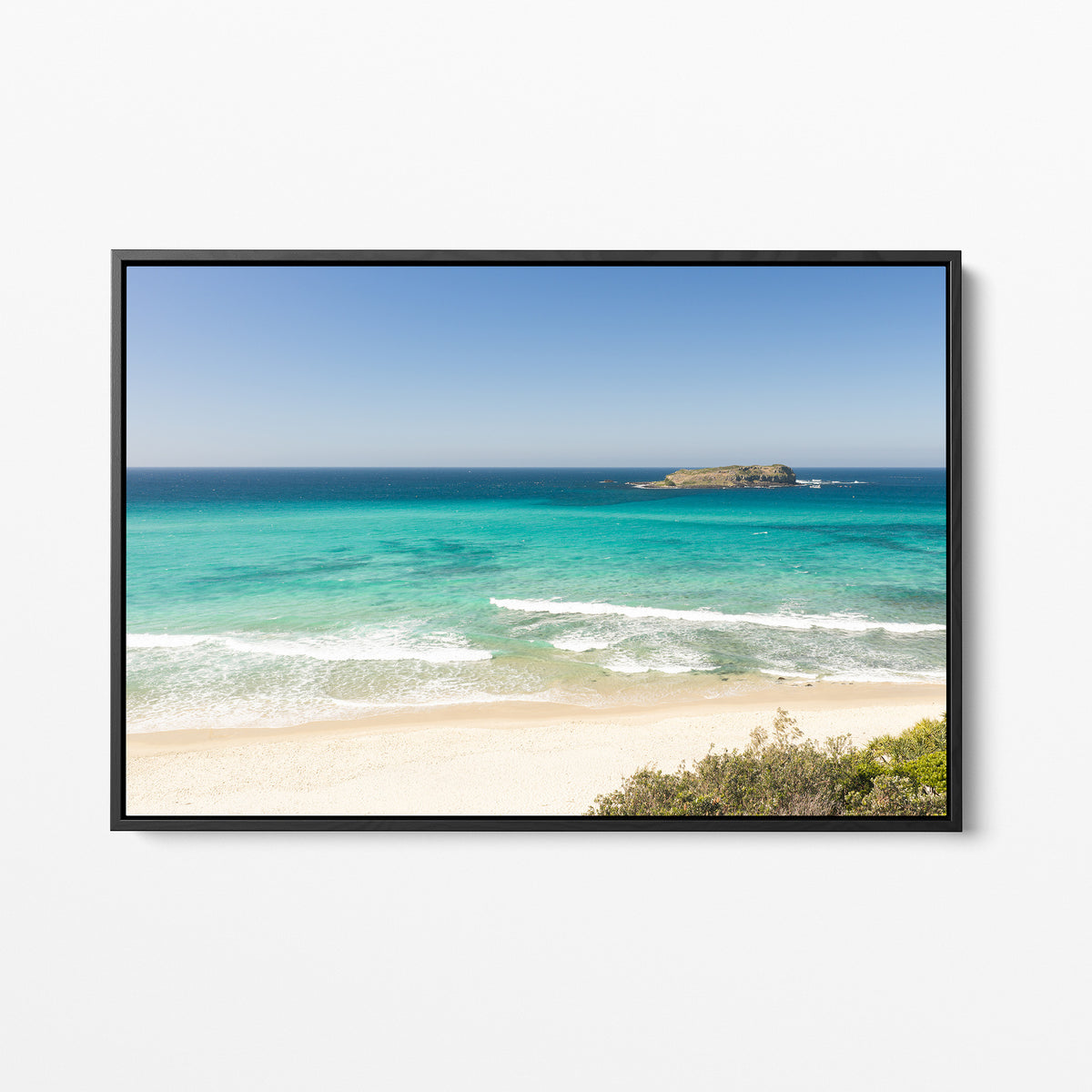 Black framed canvas print of aerial photography of Fingal Head, a beach with a small island offshore and turquoise water