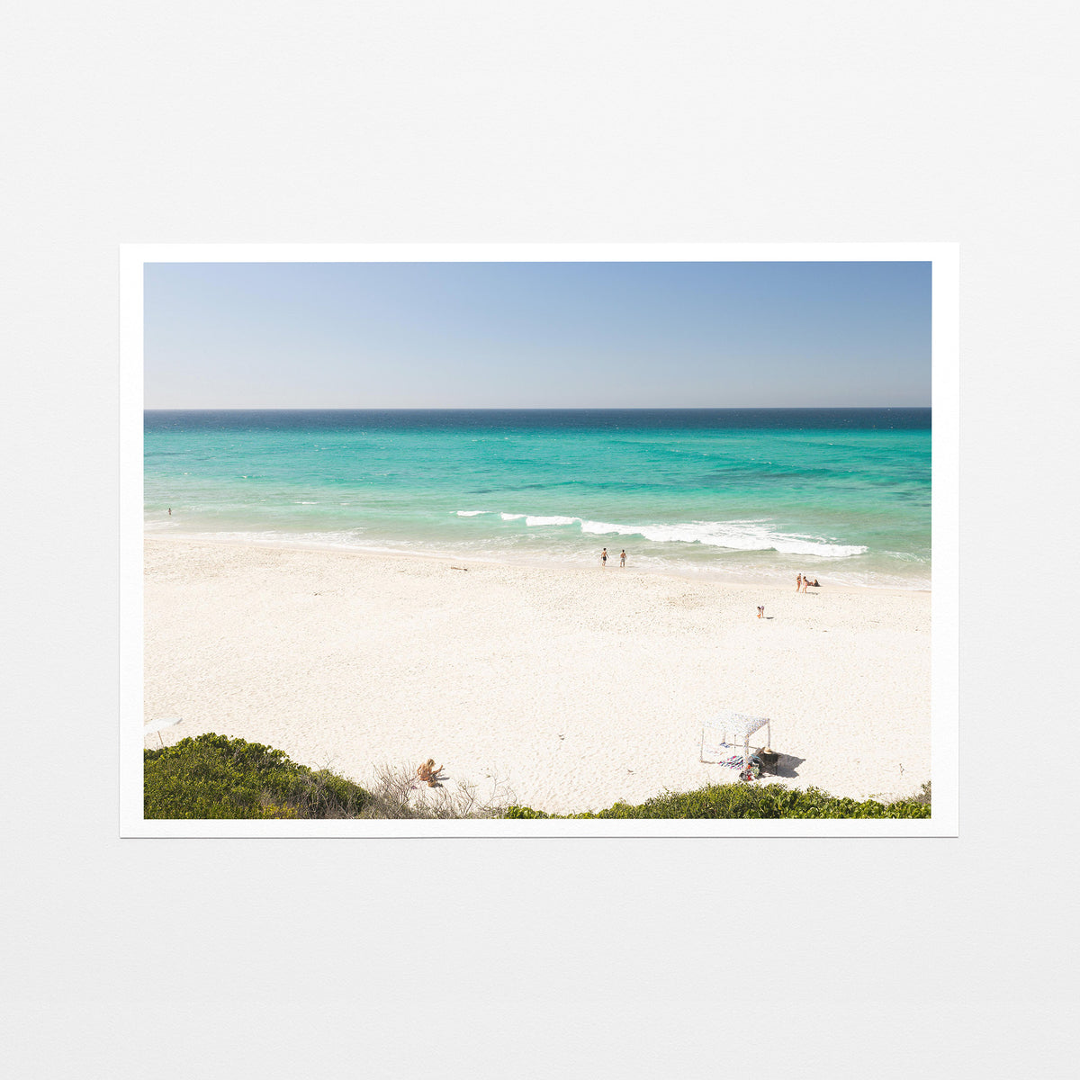 Fine art paper print of aerial photography of Fingal Head, white sand and turquoise water with a small structure and bush at the bottom with a white border