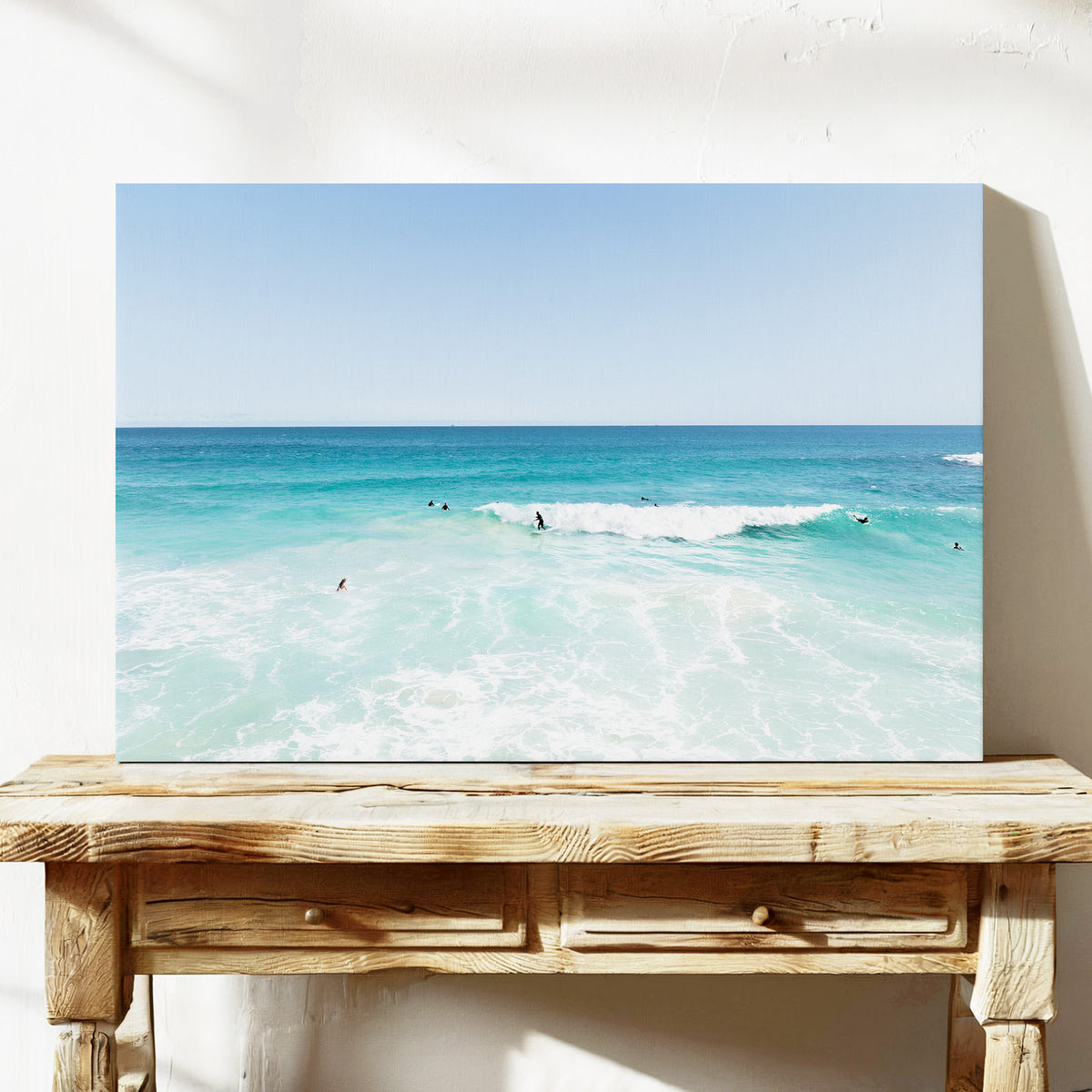 Stretched canvas print of aerial photography of Scarborough Beach, surfers waiting beside a small breaking wave in turquoise water on a console table
