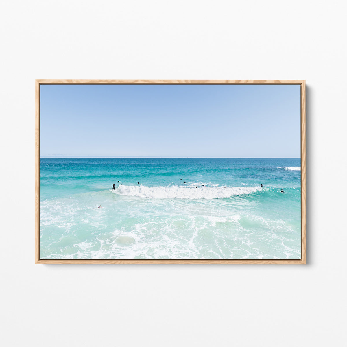 Oak framed canvas print of aerial photography of Scarborough Beach, a wide view of surfers spread across turquoise water and white foam