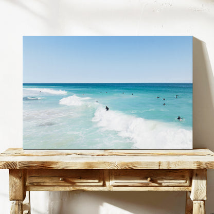 Stretched canvas print of aerial photography of Scarborough Beach, a surfer riding a breaking wave with white foam in turquoise water on a console table