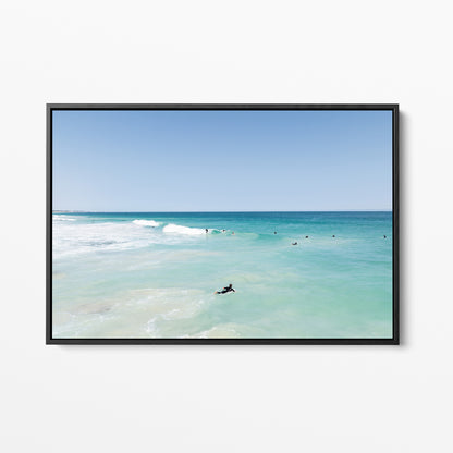 Black framed canvas print of aerial photography of Scarborough Beach, a surfer lying on a board in clear turquoise shallows